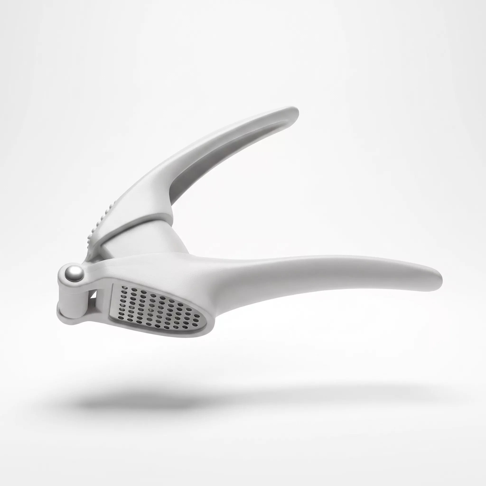 A light gray silicone garlic press tool floating against a clean white background with a soft shadow underneath.