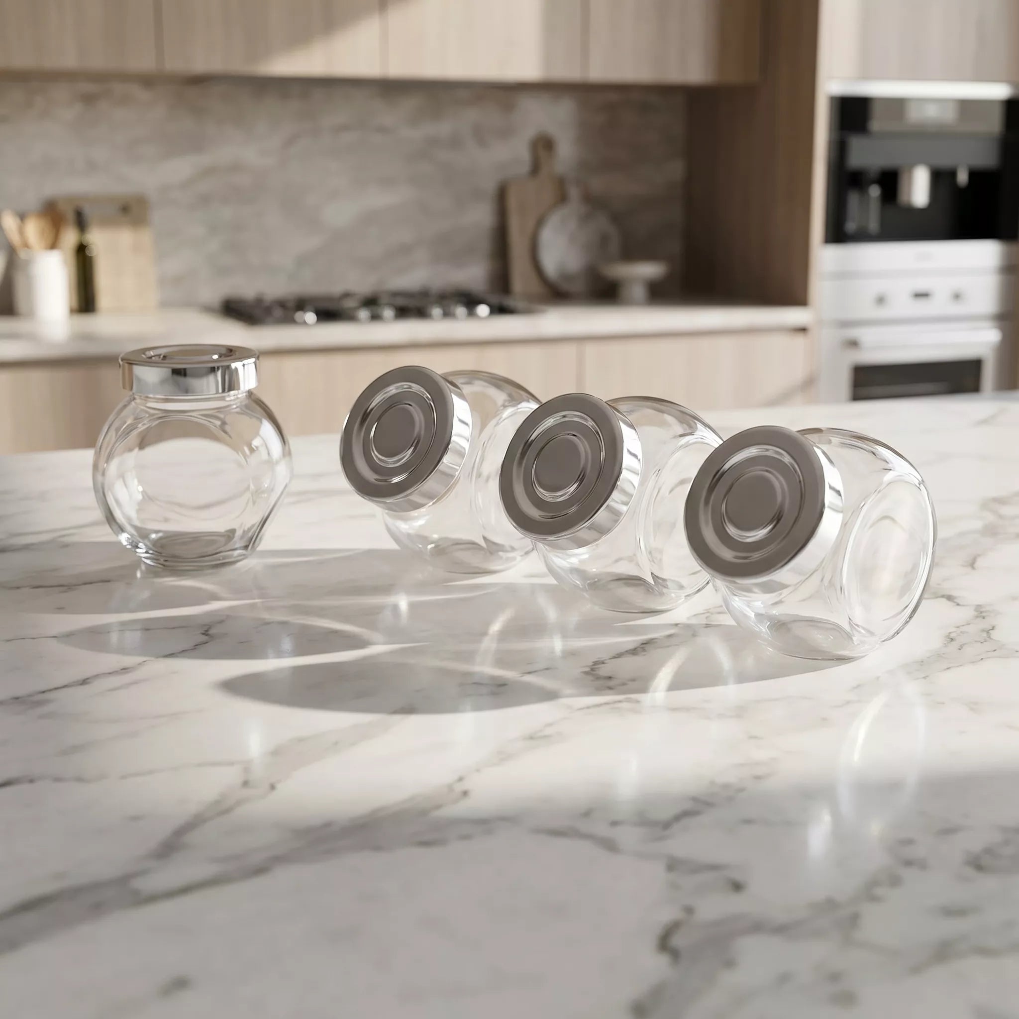 Clear glass jars with metal lids on a marble kitchen counter