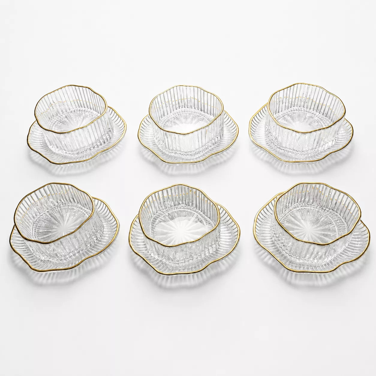 Six pairs of clear cut-glass bowls with scalloped edges and gold trim, arranged in two rows of three on a white background.