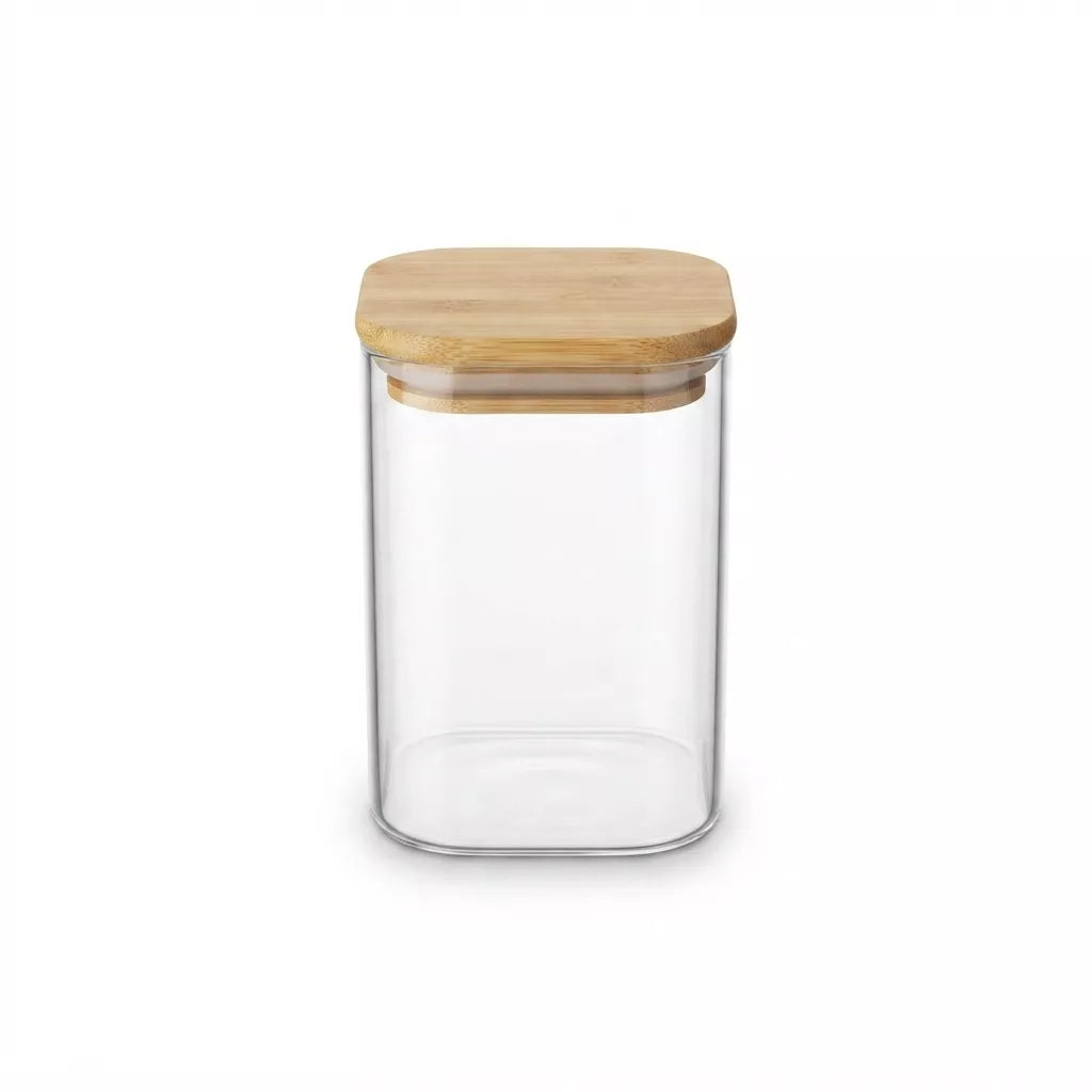 A clear glass canister with a square-shaped light brown bamboo lid, shown on a solid white background.