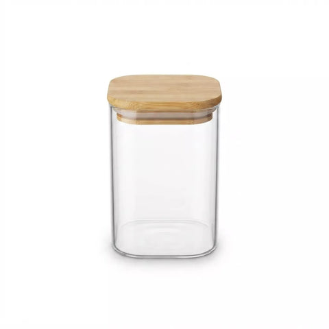 A clear glass canister with a square-shaped light brown bamboo lid, shown on a solid white background.