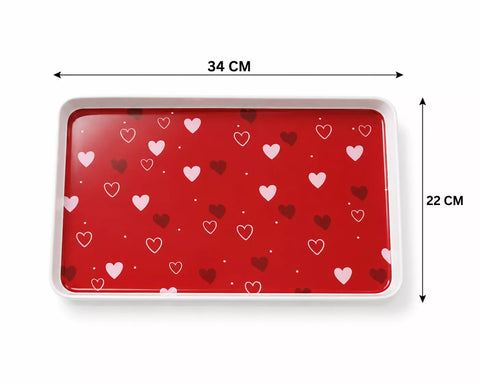 A red rectangular tray with a white border and a heart pattern, shown with dimension arrows indicating 34 cm width and 22 cm height on a white background.
