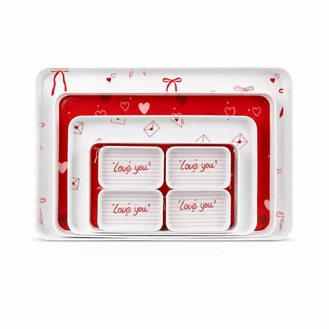 A set of nested rectangular trays with a Valentine's Day theme. The outer tray is white with red hearts and bows, the middle tray is solid red, and the inner trays are white with red hearts and the words 'Love you' printed in red script.