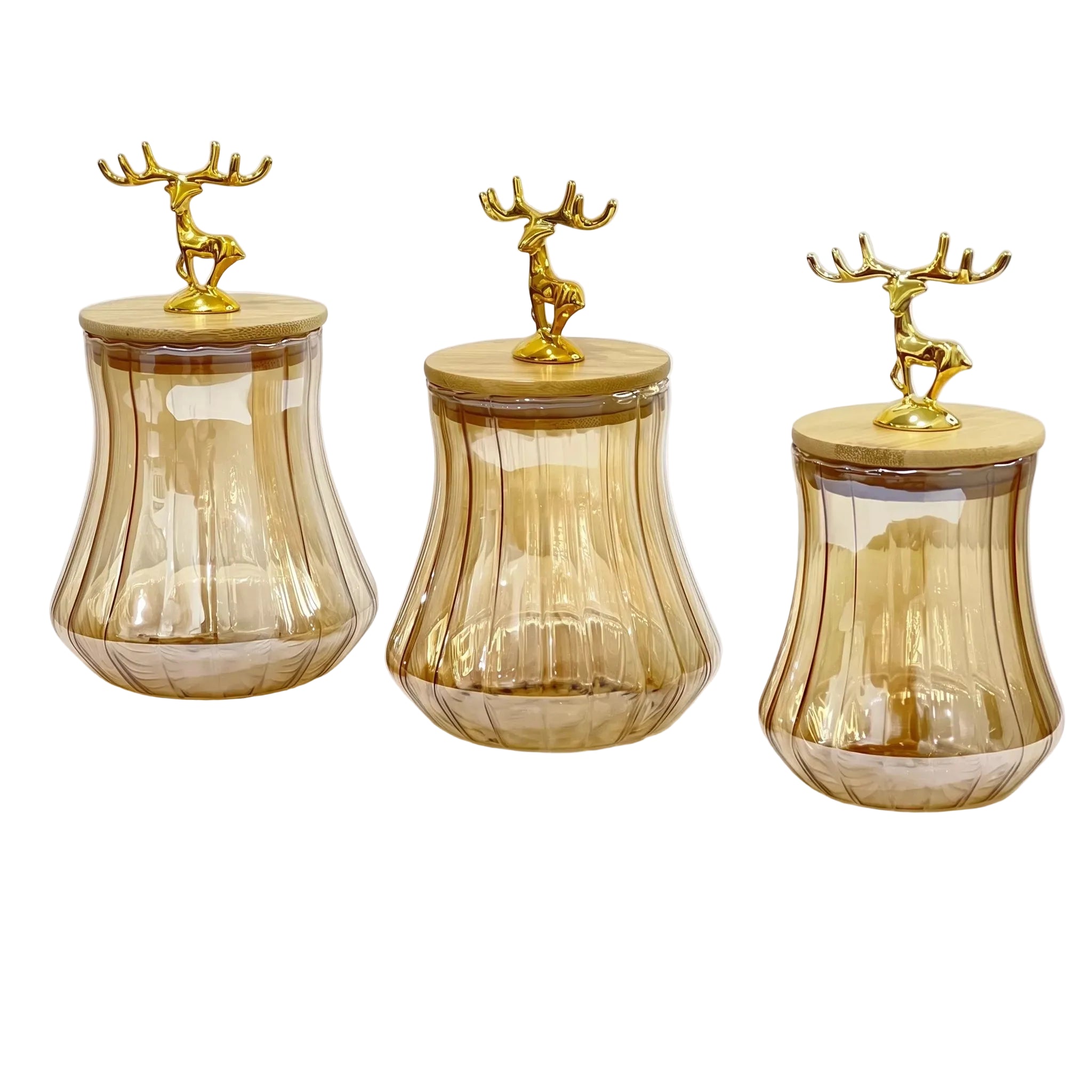 Three amber glass storage jars with fluted sides and light wood lids, each topped with a small gold deer figurine, shown on a white background.