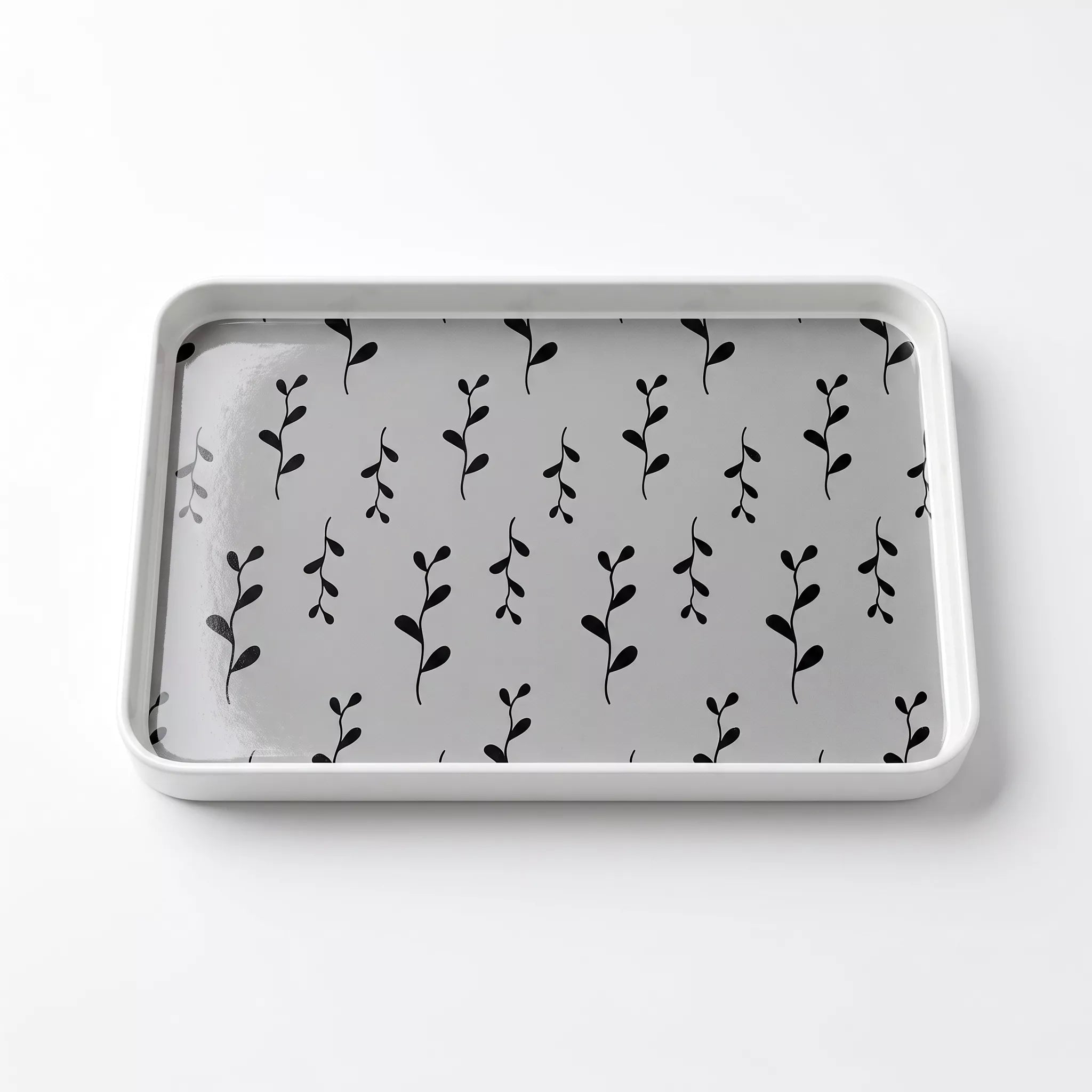 A rectangular gray tray with rounded corners, featuring a repeating black leafy vine pattern on the interior, shown on a clean white background.