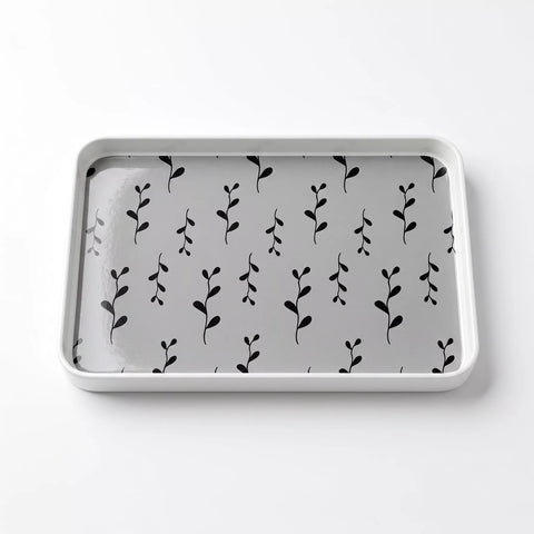 A rectangular gray tray with rounded corners, featuring a repeating black leafy vine pattern on the interior, shown on a clean white background.
