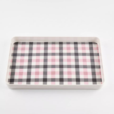 A rectangular tray with a pink, black, and white gingham plaid pattern on the interior, set against a plain white background.