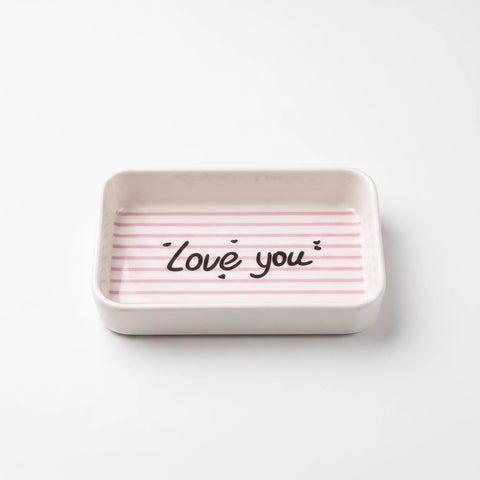 A small rectangular ceramic dish with rounded corners, featuring a light pink and white striped pattern on the inside with the words 'Love you' written in black script.